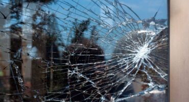 Broken Glass with outdoor street reflection. Closeup.